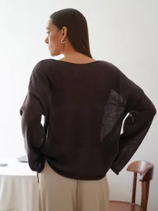 Back view of a sheer dark brown hollow knit sweater with flared sleeves and round neck.