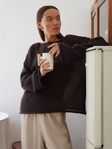 Detailed view of women's dark brown hollow knit sweater with chic flared bell sleeves