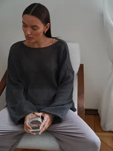 Sheer charcoal grey knit sweater featuring a wide round neck and flare sleeves