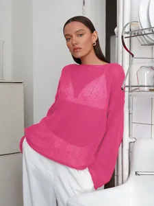 Detailed view of women's sheer fuchsia knit top featuring stylish flared bell sleeves