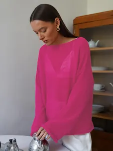Detail of sheer fuchsia hollow-out knit sweater with wide neck and flared sleeves.