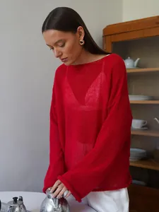 Red sheer knit sweater with hollow-out design and loose fit for women.