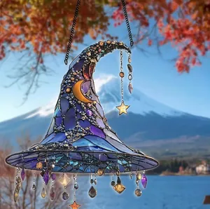 Detail of 2D acrylic witch hat suncatcher with moon and star hanging ornaments.