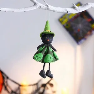 Detailed shot of a black cat witch doll Halloween hanging ornament with green accents