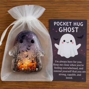 Close-up detail of Halloween pocket hug ghost ornament with greeting card and white gift bag