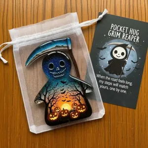 Macro view of Halloween Pocket Hug Grim Reaper acrylic token with card and organza bag