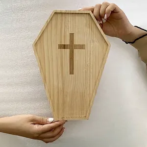 Coffin-shaped wooden Halloween serving tray featuring an engraved cross design for party.