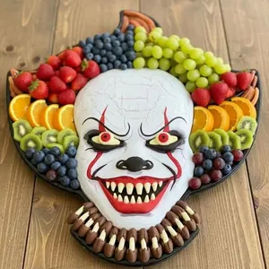 Detailed view of a Pennywise clown-shaped wooden Halloween charcuterie board with fruits