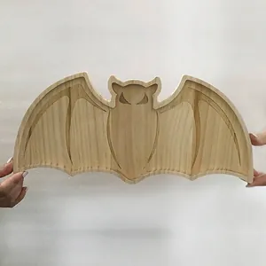 Detailed view of a bat-shaped wooden tray with natural grain for Halloween party decor