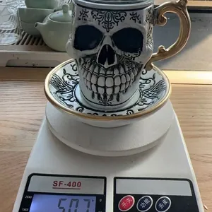 Creative resin skull mug with saucer for Halloween decoration, weighing 507g on scale.