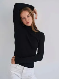 Elegant close-up of a women's black ribbed half-turtleneck slim fit knit sweater on a model
