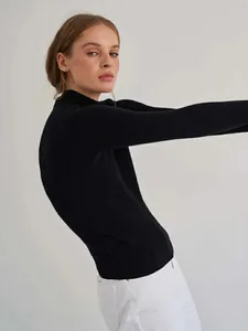 Close-up side view of a black mock neck ribbed knit sweater for a minimalist look