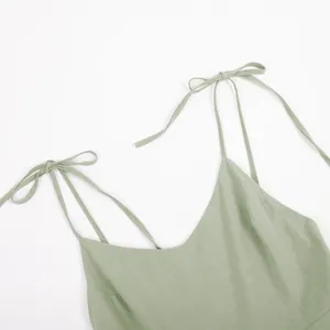 Detail of sage green pure cotton dress with V-neck and tie-up shoulder straps