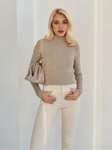 Detailed view of the women's slim-fit taupe knit sweater with a semi-high collar.