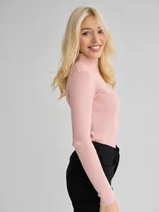 Side view of a slim-fit pink ribbed mock-neck sweater showing its soft knit texture
