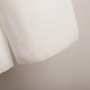 Close-up detail of soft white knitted fabric hem showing high-quality ribbing texture