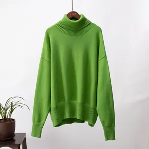 Gemütlicher hellgrüner übergroßer Rollkragenstrickpullover an einem schlichten Hintergrund