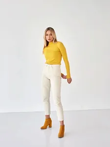 Full body model view showcasing the slim fit of the yellow mock neck ribbed sweater