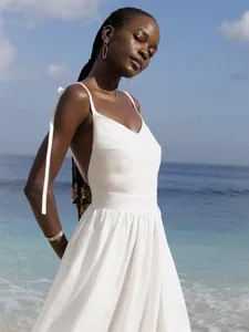 Elegant white V-neck strappy backless maxi dress for summer beach vacation