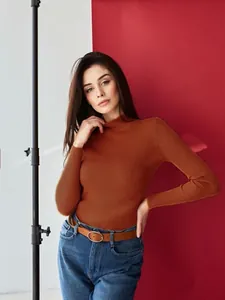 Detailed view of a slim-fit women's orange mock neck ribbed knit sweater for autumn
