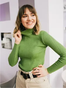 Close-up detail of women's green mock neck ribbed knit slim fit long sleeve sweater