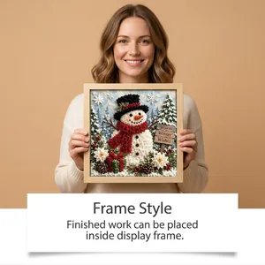 Woman holding a framed 3D Christmas snowman punch needle artwork as holiday decor