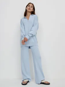 Detailed view of women's light blue polo collar sweater and wide-leg knit pants set