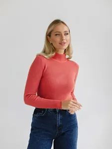 Close-up detail showing the ribbed texture of this coral mock neck knit sweater
