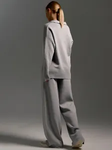 Back view of elegant grey Polo collar knit sweater and wide-leg trousers two-piece set