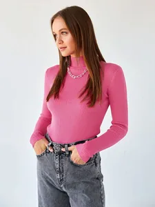 Close-up of pink ribbed mock-neck sweater showing its slim fit and knit texture