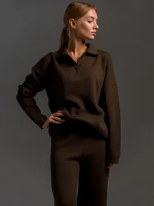 Detailed texture of chocolate brown knitted set with Polo collar sweater and trousers