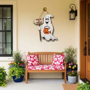 Halloween ghost door hanging decoration on a porch wall with floral garden background.
