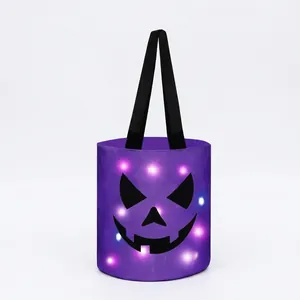Detailed view of glowing Halloween candy bucket with spooky jack-o'-lantern face