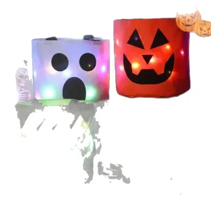 Duo of glowing LED Halloween candy buckets featuring spooky ghost and pumpkin faces