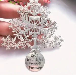 Detailed macro view of silver Christmas tree ornament with engraved friendship message pendant