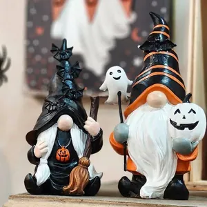 Detailed view of Halloween resin gnomes with pumpkin and ghost motifs for party decor