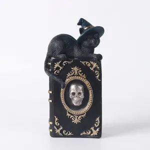 Hand-painted Halloween wizard cat figurine on a gothic magic book with skull decoration