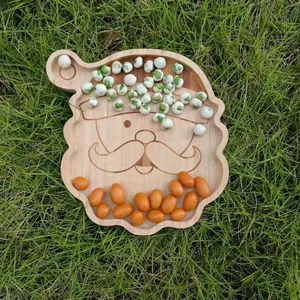 Close-up of Santa Claus-shaped bamboo snack tray filled with various nuts and peas