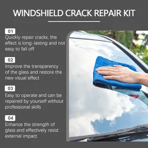 Detail of hand wiping a car windshield using a blue cloth after applying repair solution