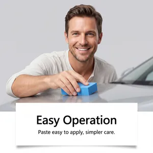 Smiling man using a blue sponge to apply scratch repair paste on a silver car