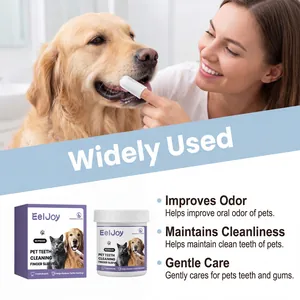Close-up showing a woman using a pet teeth cleaning finger sleeve on a golden retriever