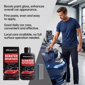 Detailed view of a man applying scratch repair paste to a blue car with a sponge