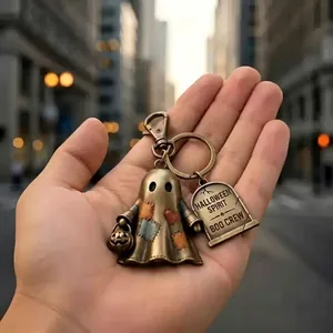 Detailed view of vintage bronze ghost keychain with Halloween Spirit Boo Crew engraving.