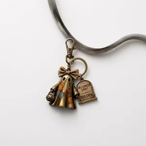 Detailed view of Halloween ghost keychain with engraved tombstone tag and bronze finish.