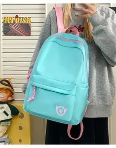 Stylish lightweight blue student backpack featuring pink straps and a unique M logo detail