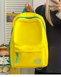 Front detail of vibrant yellow student backpack with teal zippers and logo