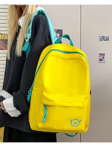 Detail of vibrant yellow high-capacity student backpack with teal straps and zippers