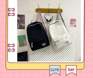 Detailed view of minimalist black and cream student backpacks in a cute school setting
