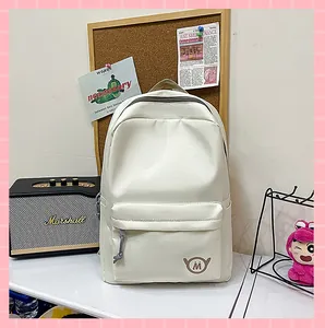 Cream white large capacity school backpack for girls displayed in a cozy study room