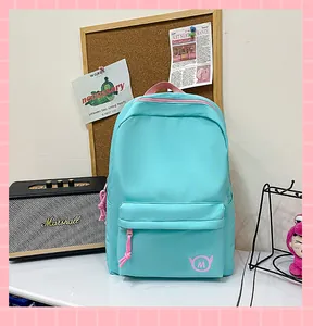 Mint green student backpack with pink accents displayed in a stylish aesthetic room setting